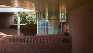 A modern interior space featuring a brick wall and glass windows.