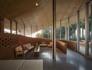 Modern living room with concrete walls and glass windows.