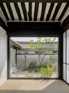 Modern house interior with glass walls and wooden floor and beams