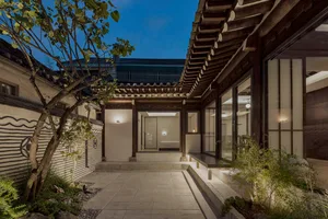 A modern residential house with a wooden exterior and a cozy courtyard.