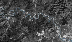 Aerial view of a mountain landscape with winding rivers and lakes.