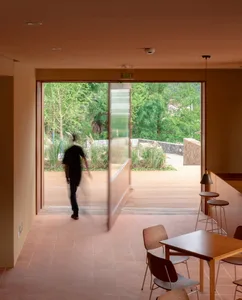 A minimalistic interior space featuring wooden furniture and flooring.