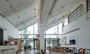 Modern lobby featuring glass, concrete, and metal elements.