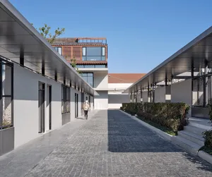 A modern exterior residential residence with concrete walls and metal railings.