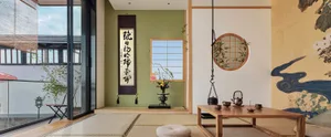 Minimalist Japanese interior design featuring bamboo furniture and traditional elements such as a hanging scroll, round mirro