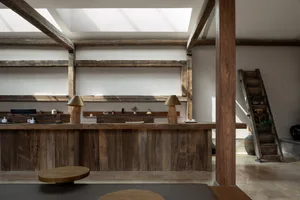 Seating arrangement in an industrial showroom featuring wooden furniture.