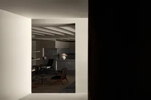 A minimalist interior design featuring concrete materials and modern furniture.