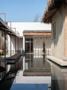A modern architectural space featuring concrete walls and glass windows.