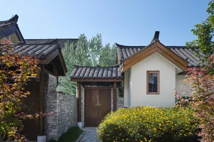 Stylish, traditional residential exterior with stone and wooden elements.