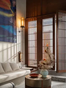 A modern living room with a painted timber floor, white sofa, and abstract art on the wall.