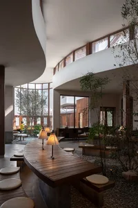 A contemporary restaurant interior featuring wood, glass, and concrete materials.