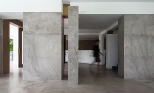 A modern living room with marble walls and floors.