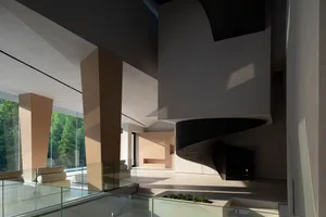 Modern interior design featuring exposed concrete walls and floors in a living room setting.