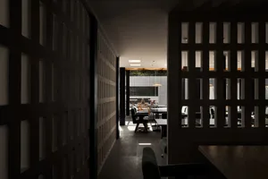 A modern restaurant interior with wooden furniture and a spacious seating area.