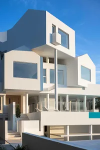 Modern residential architecture featuring concrete, glass, and steel materials.