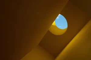Modern interior design featuring a yellow concrete ceiling with a sky window.