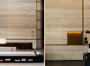 A modern minimalist lobby with a marble wall and floor, featuring sleek and contemporary design.