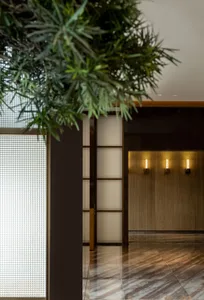 A modern lobby with wooden walls and marble floors.