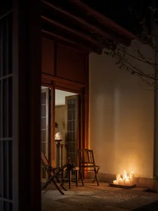 A serene, modern indoor space featuring wooden furniture, a candle arrangement, and natural light.