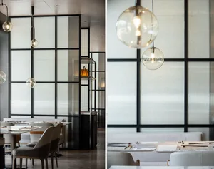 Modern restaurant with a glass wall and white seating.