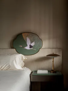 A modern bedroom featuring an intricate crane headboard