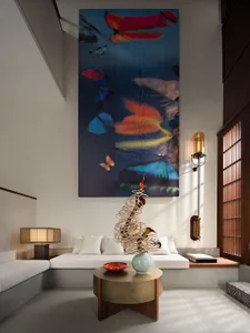 A modern living room with a large abstract art piece featuring colorful butterflies on the wall.