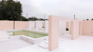 A minimalist swimming pool space constructed with concrete.