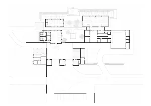 Modern office space layout with glass partitions, concrete flooring, and steel structural elements.