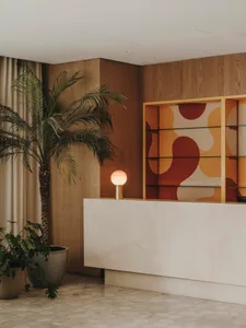 A modern reception space featuring wood, marble, and glass materials.