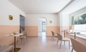 Minimalist cafeteria space featuring concrete and glass elements.