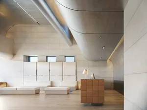 Modern minimalist office space with concrete walls and floors.