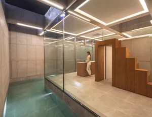 Industrial-style interior design featuring concrete walls and floor, with modern wooden accents.