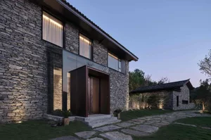 Modern residential exterior with stone and glass materials