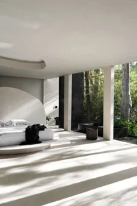 Modern minimalist bedroom featuring concrete flooring with natural light streaming in from a garden view.