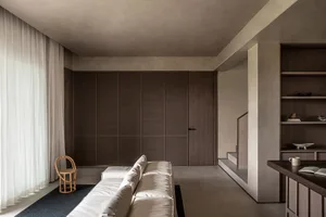 Interior design featuring minimalist architectural style with concrete and wooden elements.
