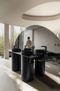Modern bathroom with black metallic sinks and fixtures.