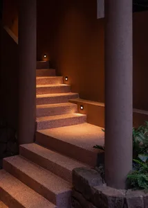 Concrete stairs illuminated by warm lights at night.