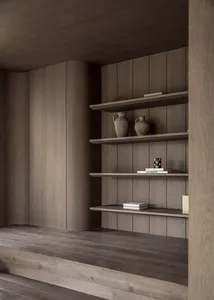 A minimalist living room with a built-in wooden bookshelf containing decorative vases and books.