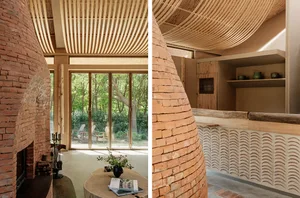 A modern minimalist living space featuring exposed brick walls and a curved ceiling, with natural light streaming in through 