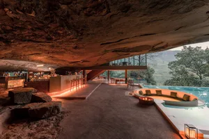 A modern residential space featuring concrete materials and a cave-like architecture