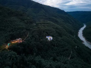 A modern residential lodge nestled in a forest on a mountain