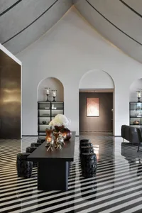 A modern living room with a striking concrete floor and minimalist design elements.