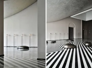 Modern lobby with sleek, geometric marble floors and contemporary lighting fixtures.