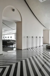 A minimalist office interior featuring modern marble and glass elements.