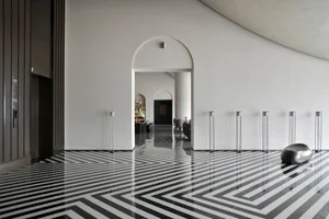 A modern minimalist entryway featuring a concrete and glass design.