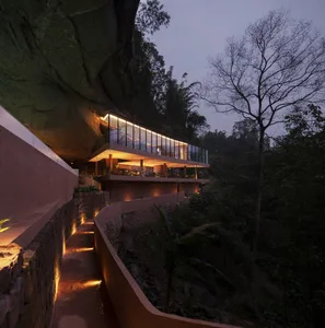 Modern residential building with concrete and glass structural elements.