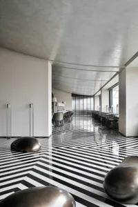 A modern restaurant interior with a striking black and white tiled floor.
