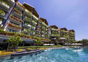 Modern residential building with concrete, glass, and plant balconies
