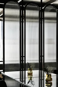 A minimalist interior design featuring a glass wall structure.