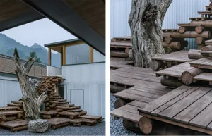 A rustic outdoor space featuring wooden logs and a mountainous backdrop.